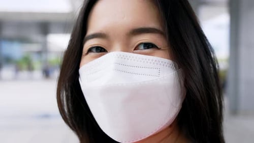 Young Adult Wearing Mask and Vaccination Bandage