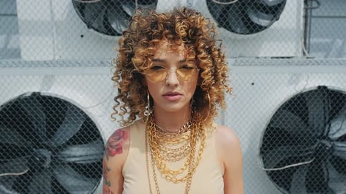 Stylish Woman Posing in Front of Industrial Fans