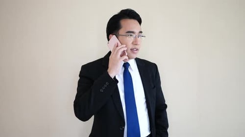 Asian young businessman talking at phone.