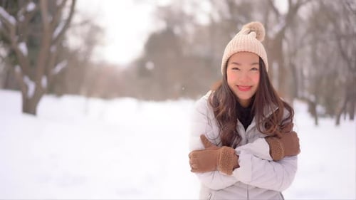 Woman Smiles in Snowy Winter Wonderland