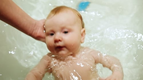 Adorable Infant Enjoying Bath Time