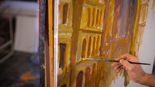 A Male Artist Painting In His Studio