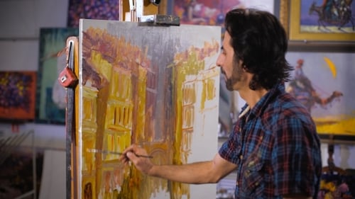 A Male Artist Painting In His Studio