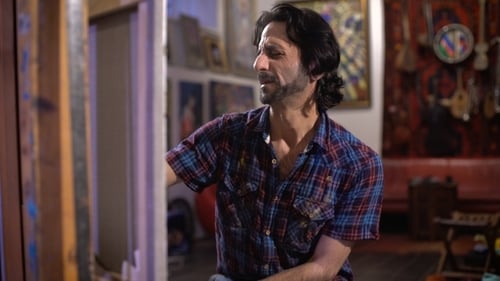 Man with Dark Hair Painting in Studio