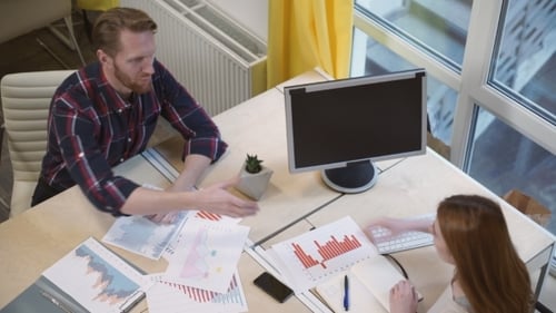Business Meeting and Handshake at Office Desk