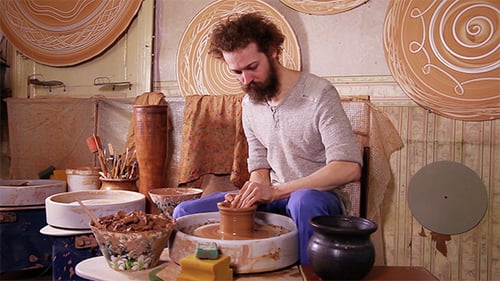 Man Shaping Clay Pot on Pottery Wheel