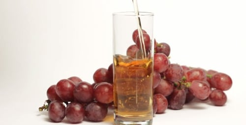 Grape Juice Being Poured into Glass