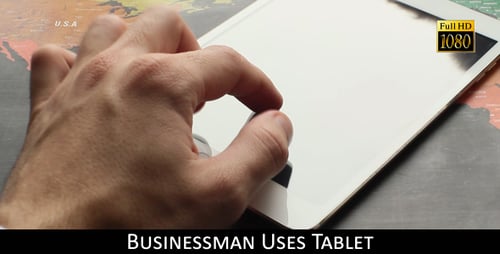 Hand Interacting with Tablet Device on World Map