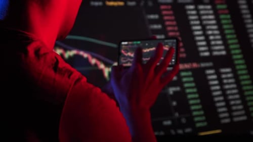 Trader Analyzes Cryptocurrency Charts on a Smartphone Screen in ...
