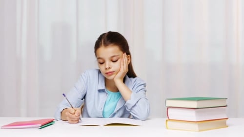 Bored School Girl With Books And Notepad At Home