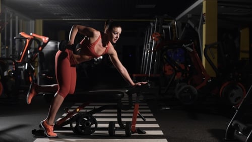 Young Woman Making Exercise At The Gym