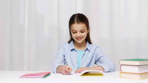 Happy School Girl With Books And Notepad At Home