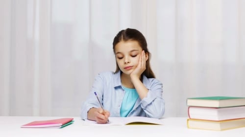 Bored School Girl With Books And Notepad At Home