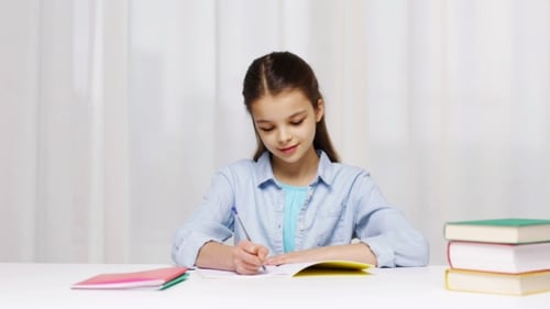 Happy School Girl With Books And Notepad At Home