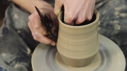 Potter Shaping Clay on Rotating Wheel
