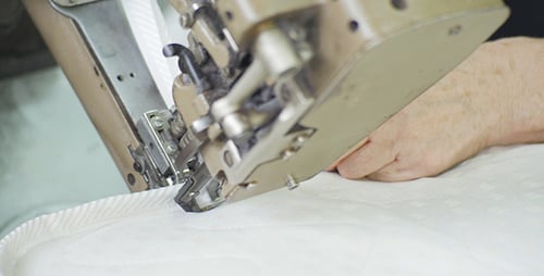 Machine Sewing Mattress Edge in Manufacturing Setting