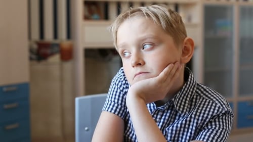 Blond Boy Contemplating at Desk