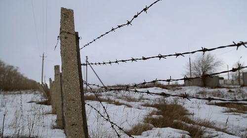 Barbed Wire Fence in Cold Winter Landscape