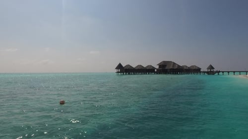 Bungalow Huts In Sea On Tropical Resort Beach 23