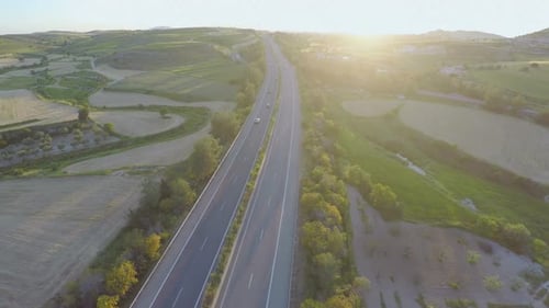 Busy Traffic on Motorway. Aerial Shot of Road, Beautiful Nature. Amazing Sunset