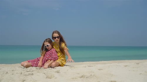 Little Happy Funny Girls Have a Lot of Fun at Tropical Beach Playing Together.