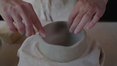 Hands Shaping a Clay Bowl in a Home Studio