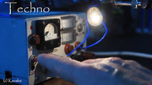 Hand Switching on Retro Electronic Device with Light Bulb