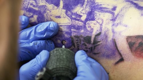 Tattooing On The Body. Tattoo Artist Make Tattoo In Studio