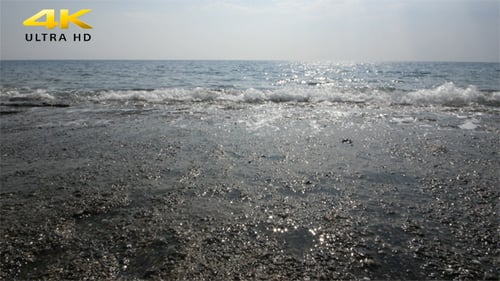 Gentle Waves on a Sunny Beach Shoreline