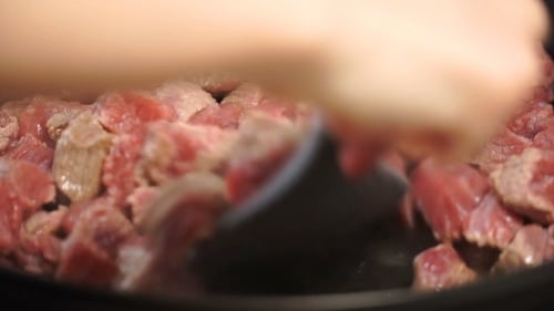 Girl Fry Finely Chopped Meat In a Frying Pan