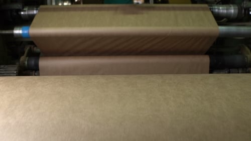 Industrial Machine Rolling Out Brown Paper