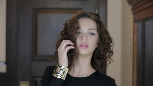 Curly Brunette Posing On Camera