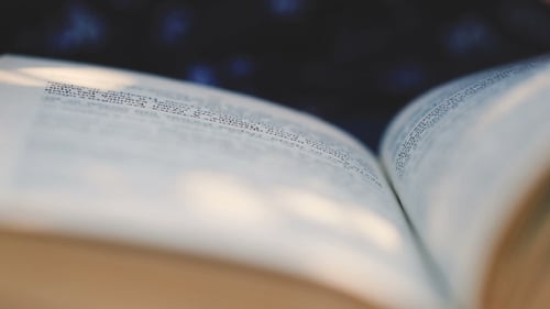 Hand Turning Pages in a Book