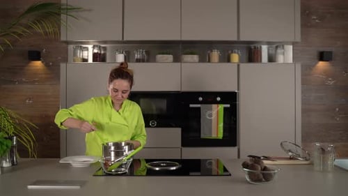 Woman Chef Cooking Meal Preparation in Kitchen