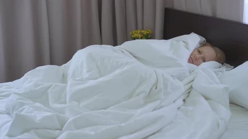 Woman Lying in Bed, Unable to Sleep