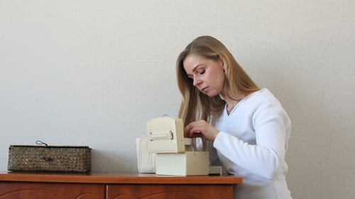 Woman Opening Jewelry Box on Dresser