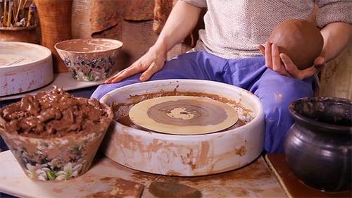 Potter Works in His Workshop