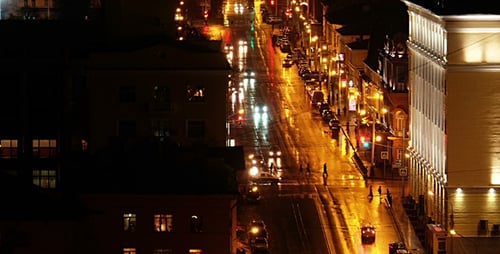 City Street Traffic at Night After Rain