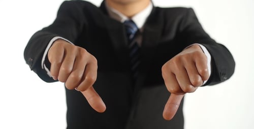Businessman Giving Thumbs Down on White Background