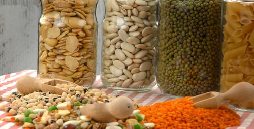 Assorted Dried Foodstuffs in Jars with Wooden Scoops