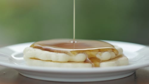 Pancakes with Syrup Being Poured on Top