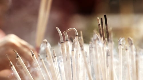 Smoldering Incense Sticks Emitting Fragrant Smoke