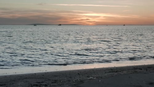 Sunset Light and Gentle Waves Along the Coast