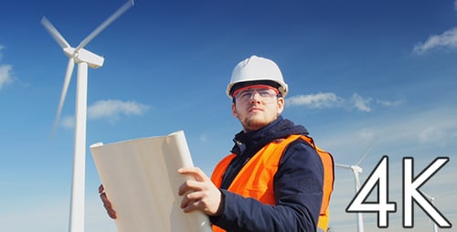 Wind Turbine Engineer Inspecting Blueprint Outdoors