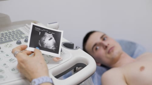 Of Male Radiologist Operating Ultrasonic Machine With Sonography Print On Keypad