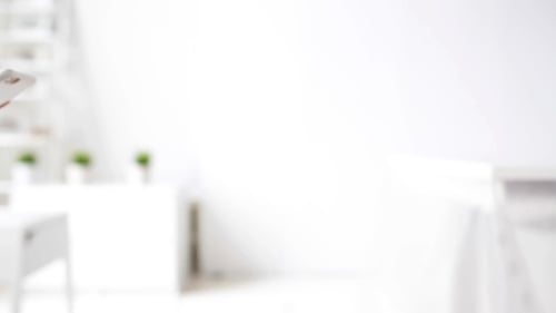 Woman's hands using a smartphone indoors