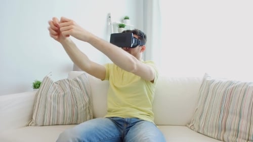 Man Experiencing Virtual Reality Headset on Couch