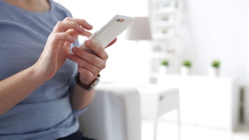 Woman Using Smartphone at Home