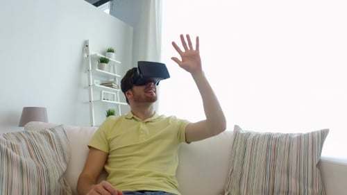 Young Man Experiencing Virtual Reality Headset on Couch