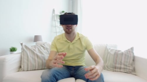 Adult Immersed in Virtual Reality on Couch